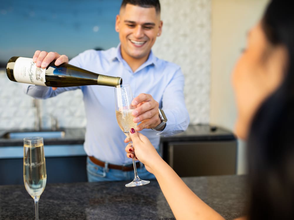 Residents enjoying the bar in the clubhouse at The Halsten at Chauncey Lane in Scottsdale, Arizona