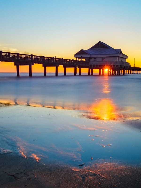 Sun setting behind a pier near Tuscany Pointe at Tampa Apartment Homes in Tampa, Florida