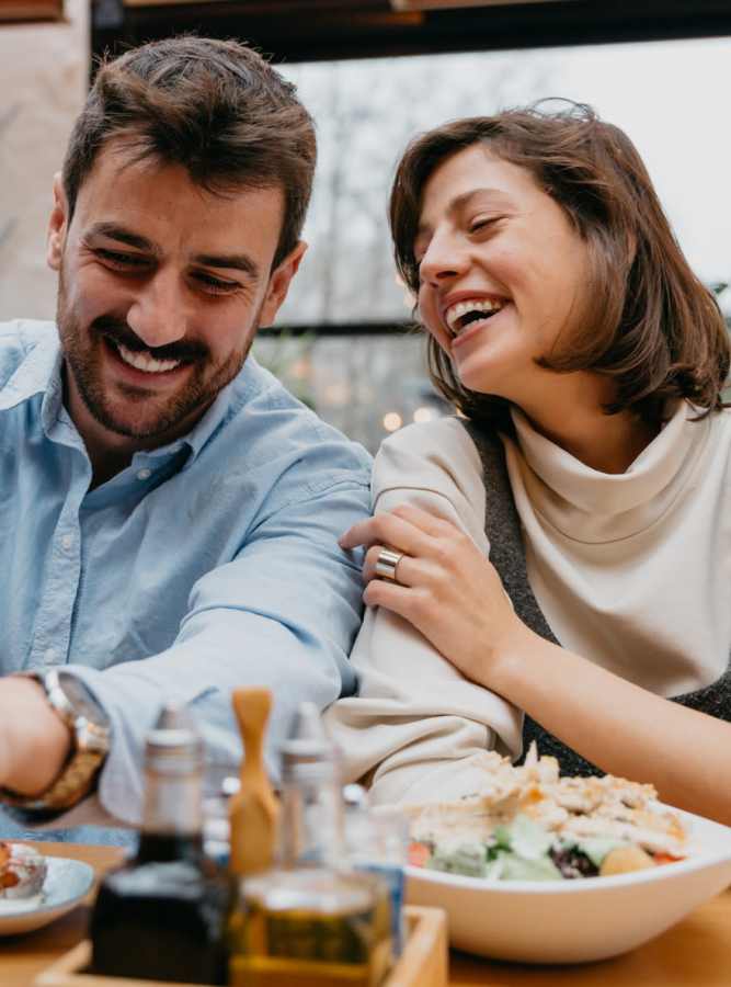 Couple laughing at the dinner table at Webster, NY in Webster, New York