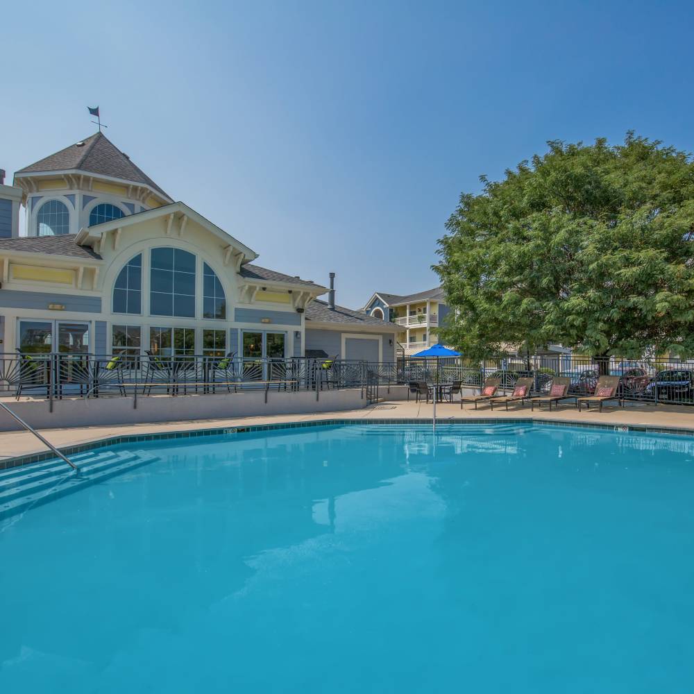 Community with shared swimming pool amenities at One Belmar Place in Lakewood, Colorado