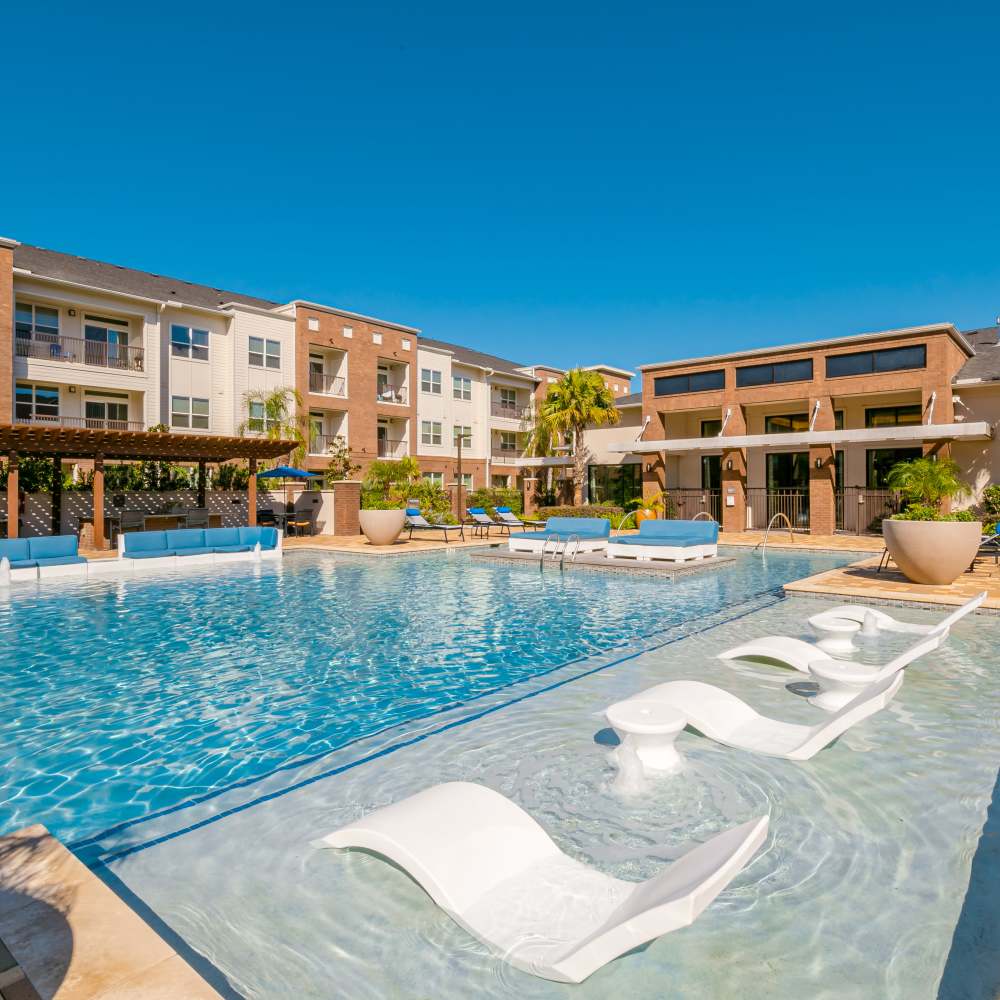 Pool with lounge beds at NOVU New Forest in Houston, Texas