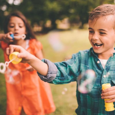 Kids playing with bubbles at a near by part at Broadmoor in Joint Base Lewis McChord, Washington