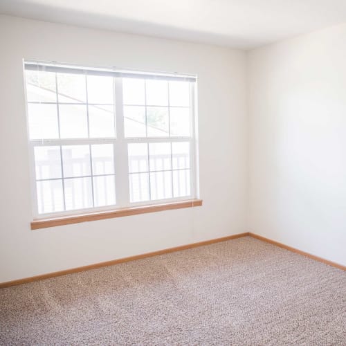 Single bedroom with a large window at Walnut Place in Ames, Iowa