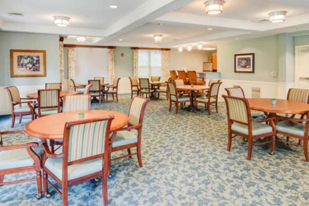 Community lounge area with tables at Victory Crest Apartments in Hyattsville, Maryland