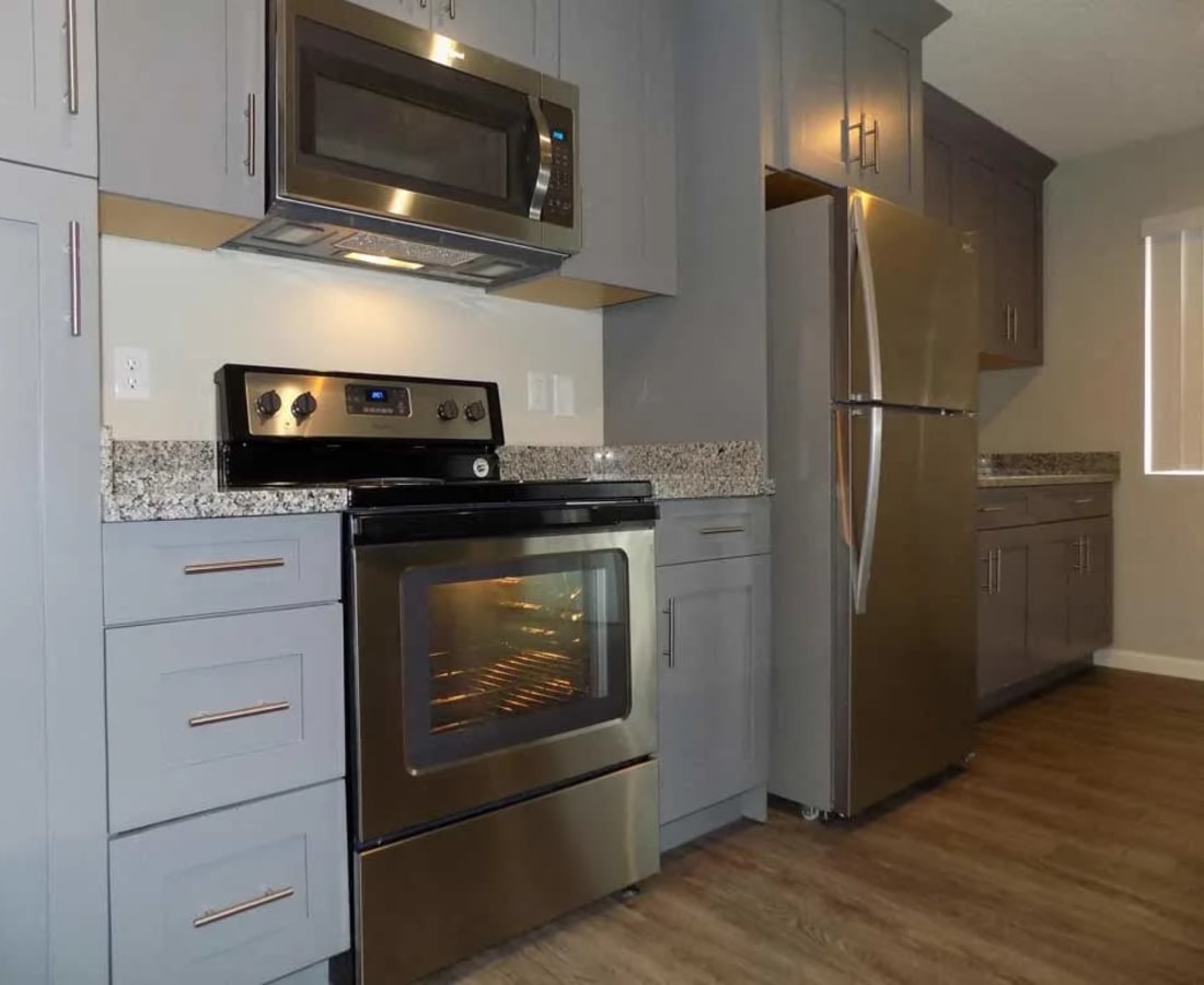 Model kitchen with stainless-steel appliances at The Palms Apartments in Sacramento, California