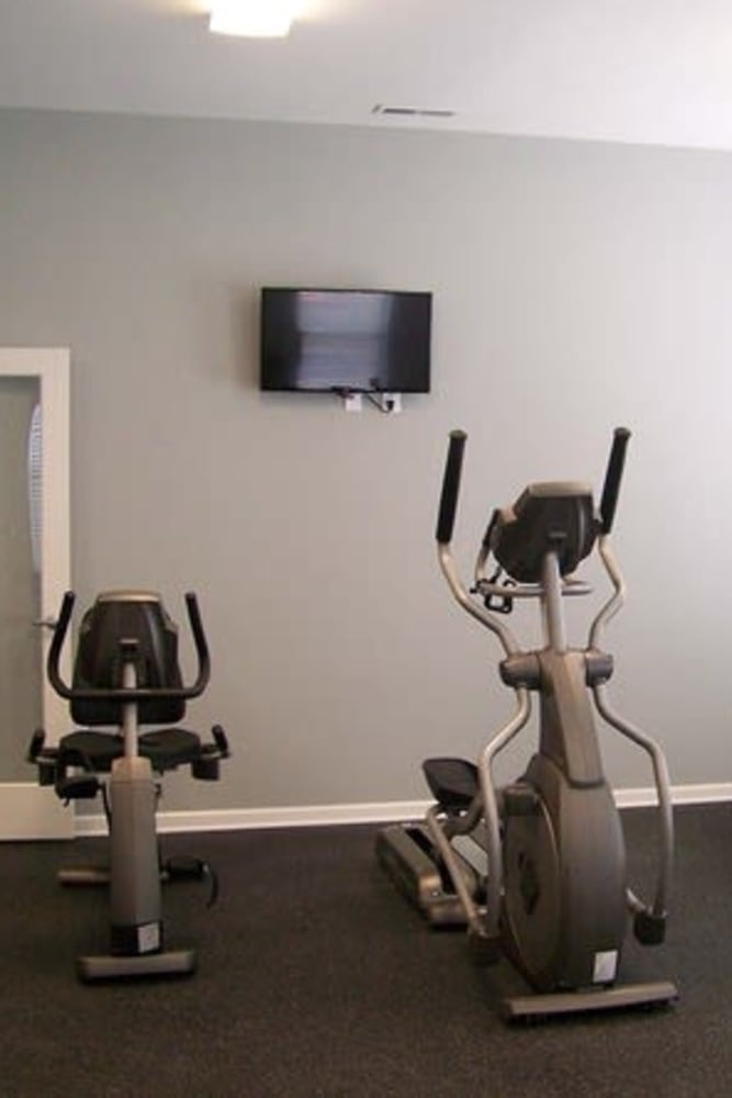 Residents fitness center with treadmill at Oak Grove Crossing Apartments in Newburgh, Indiana