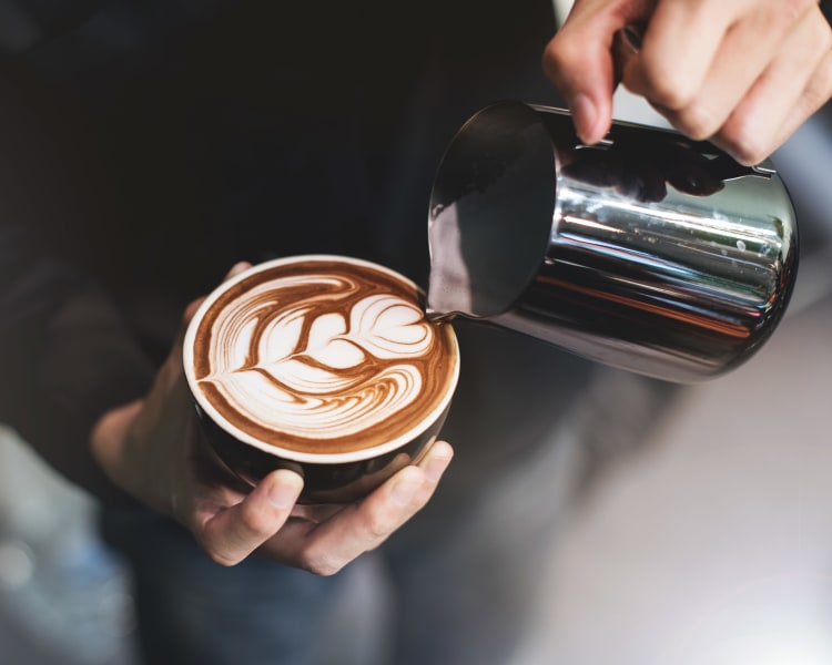 Barista making a latté for a customer near Sofi Westview in San Diego, California