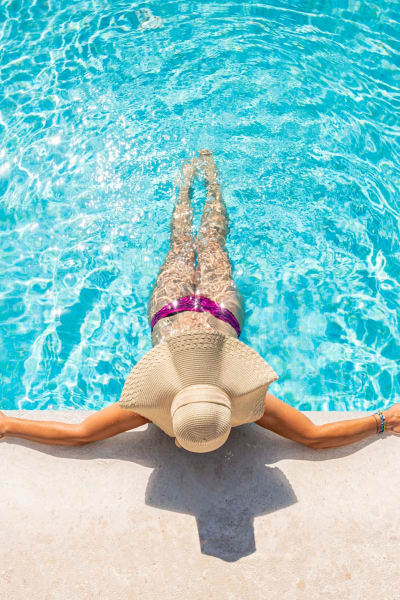 Resident lounges in the pool at Ironwood at Happy Valley in Phoenix, Arizona