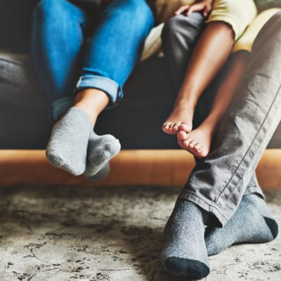 Family feet hanging off couch in living room at Heroes Manor in Camp Lejeune, North Carolina