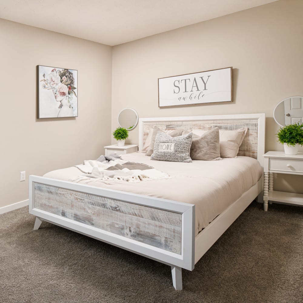 Cozy bedroom in a model home at Bradford Place Apartments in Byram, Mississippi