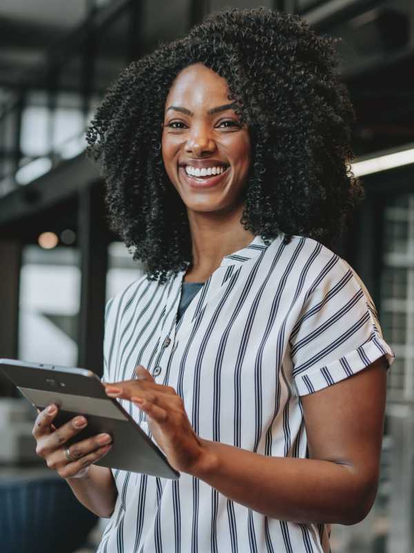 A woman holding a tablet at Peters Residential in Culver City, California