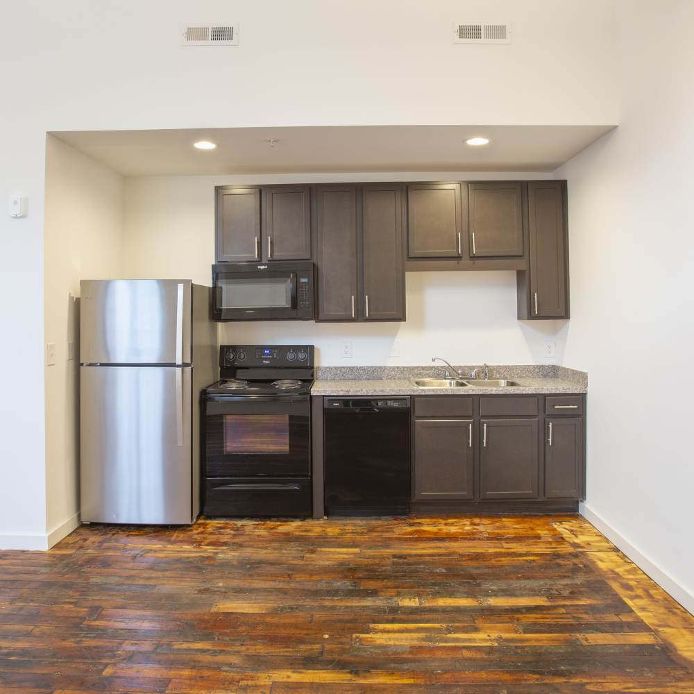 Wood-style floored apartment with well-equipped kitchen at Lofts at Inman Mills in Inman, South Carolina