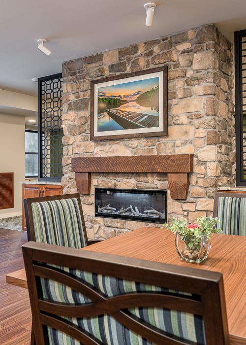 Resident dining hall with electric fireplace at The Pillars of Grand Rapids in Grand Rapids, Minnesota