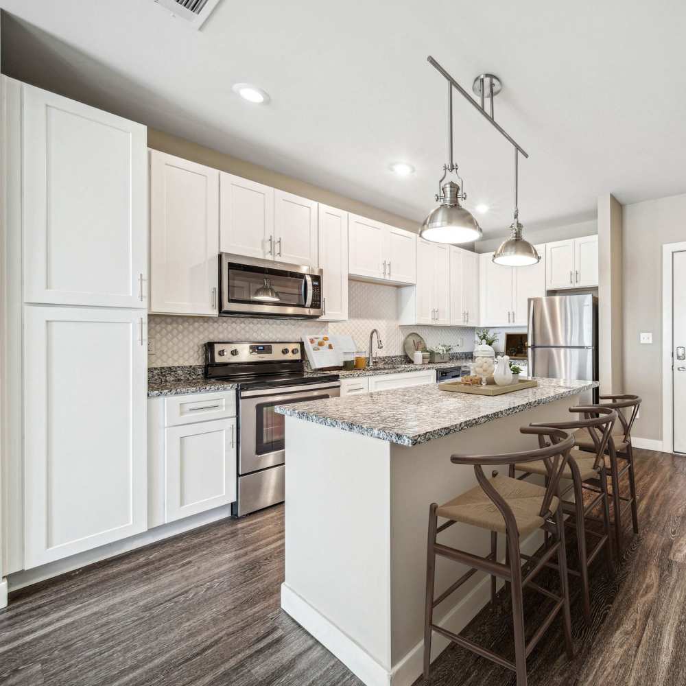 Well-designed gourmet kitchen with white cabinetry at Chroma in Saint Louis, Missouri