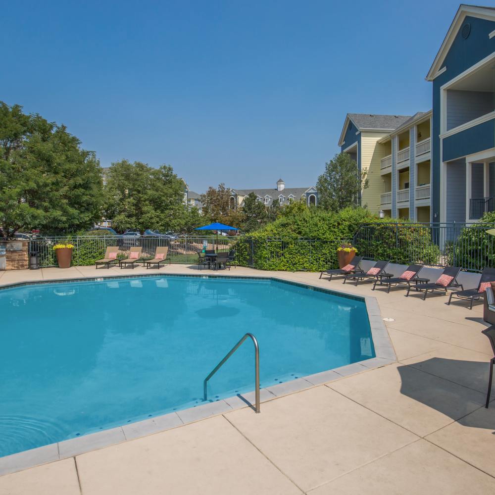 Clear blue swimming pool with calm water surface at One Belmar Place in Lakewood, Colorado