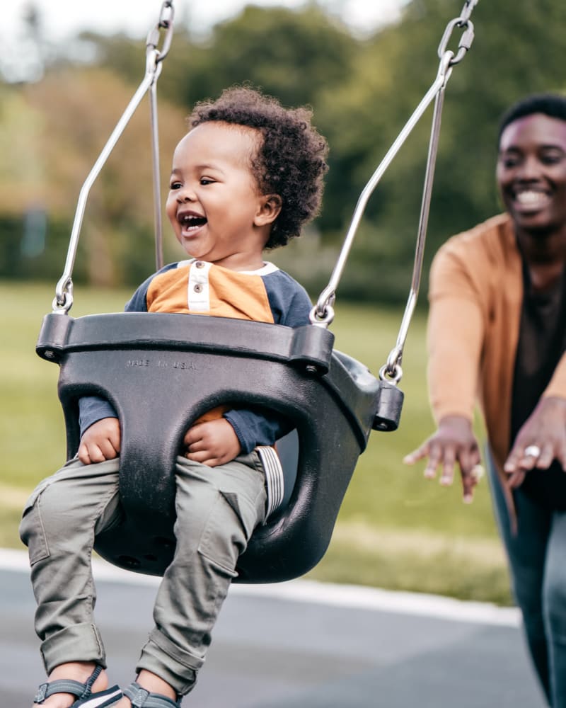 A mother pushing her child on a swing near Integra Heights in Clermont, Florida