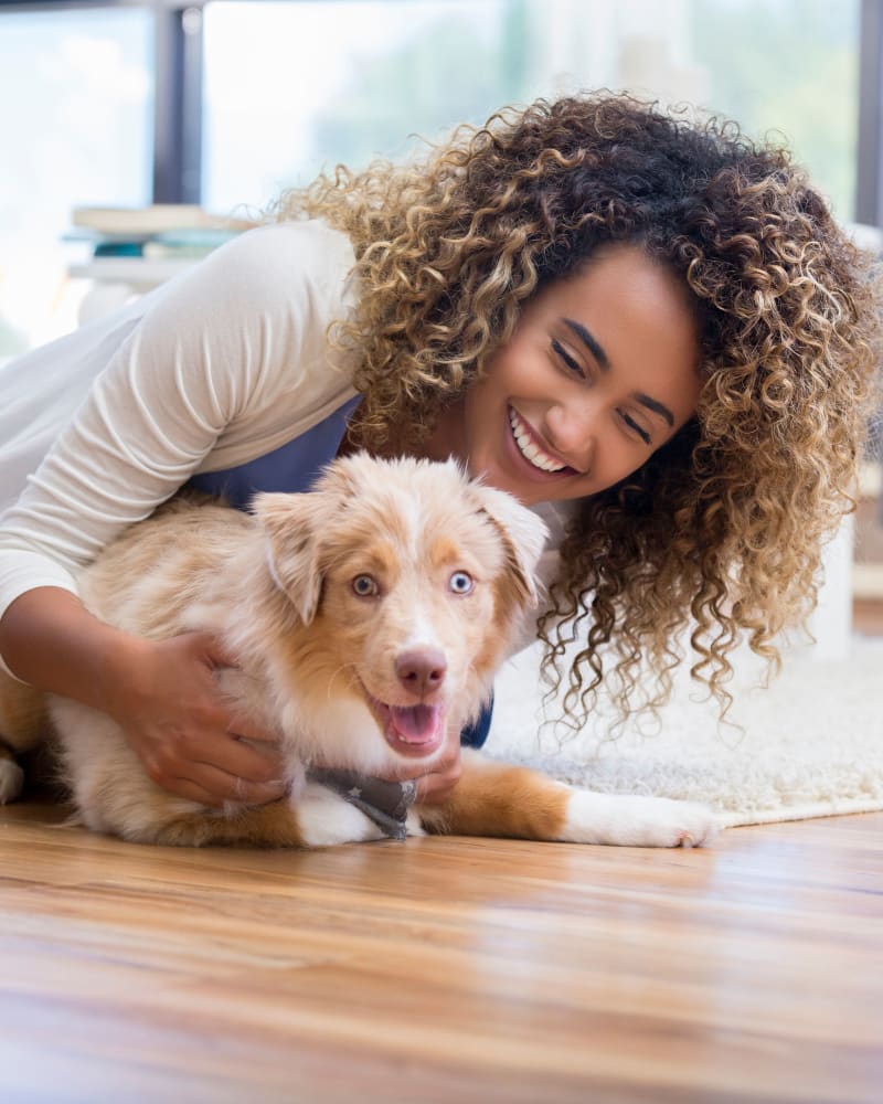 Resident having a great time with her pet at The Riverview in Charleston, South Carolina