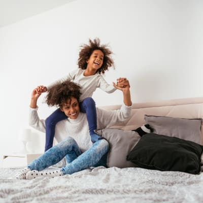 Mother playing with her kid in bedroom at Longshaw Road in Annapolis, Maryland