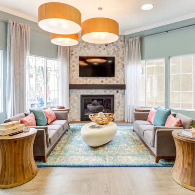 Beautifully decorated lobby interior with comfortable seating in front of the fireplace at Sofi Westview in San Diego, California