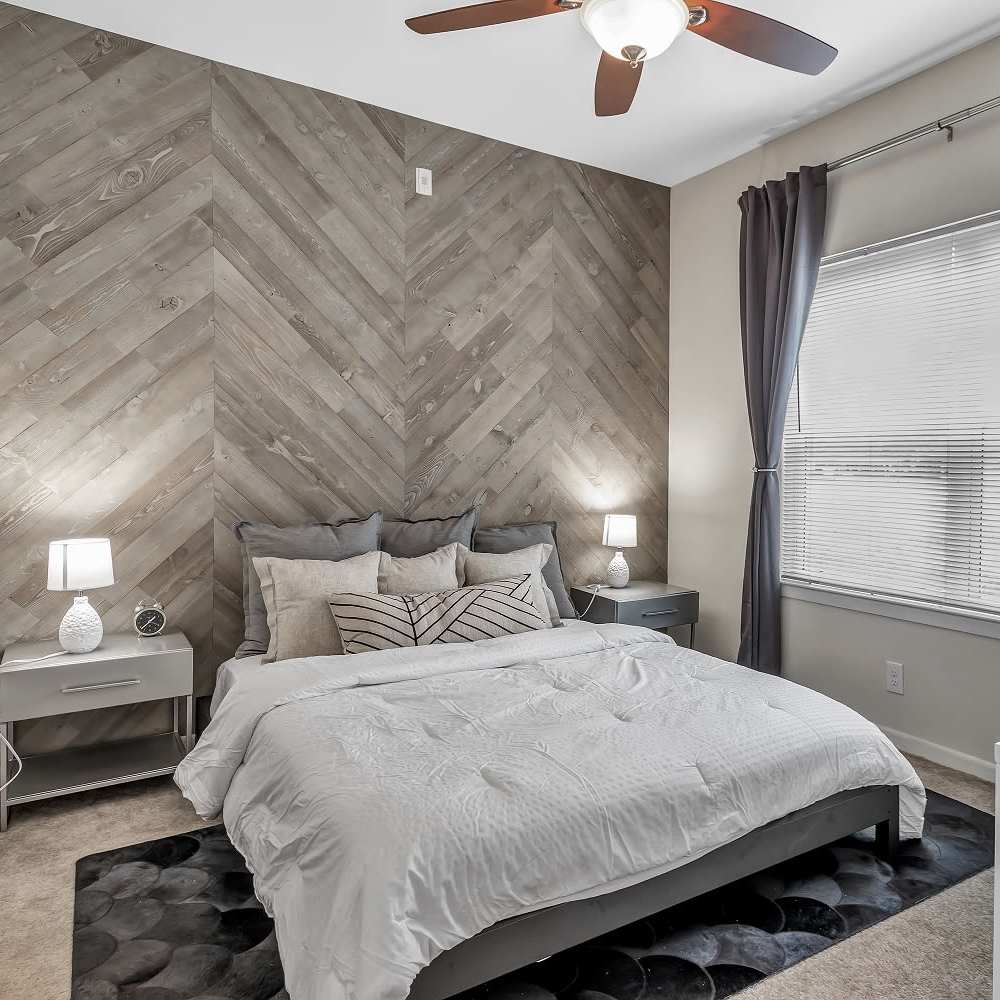 Modern bedroom with sophisticated furniture at Regency Gardens in Bryan, Texas