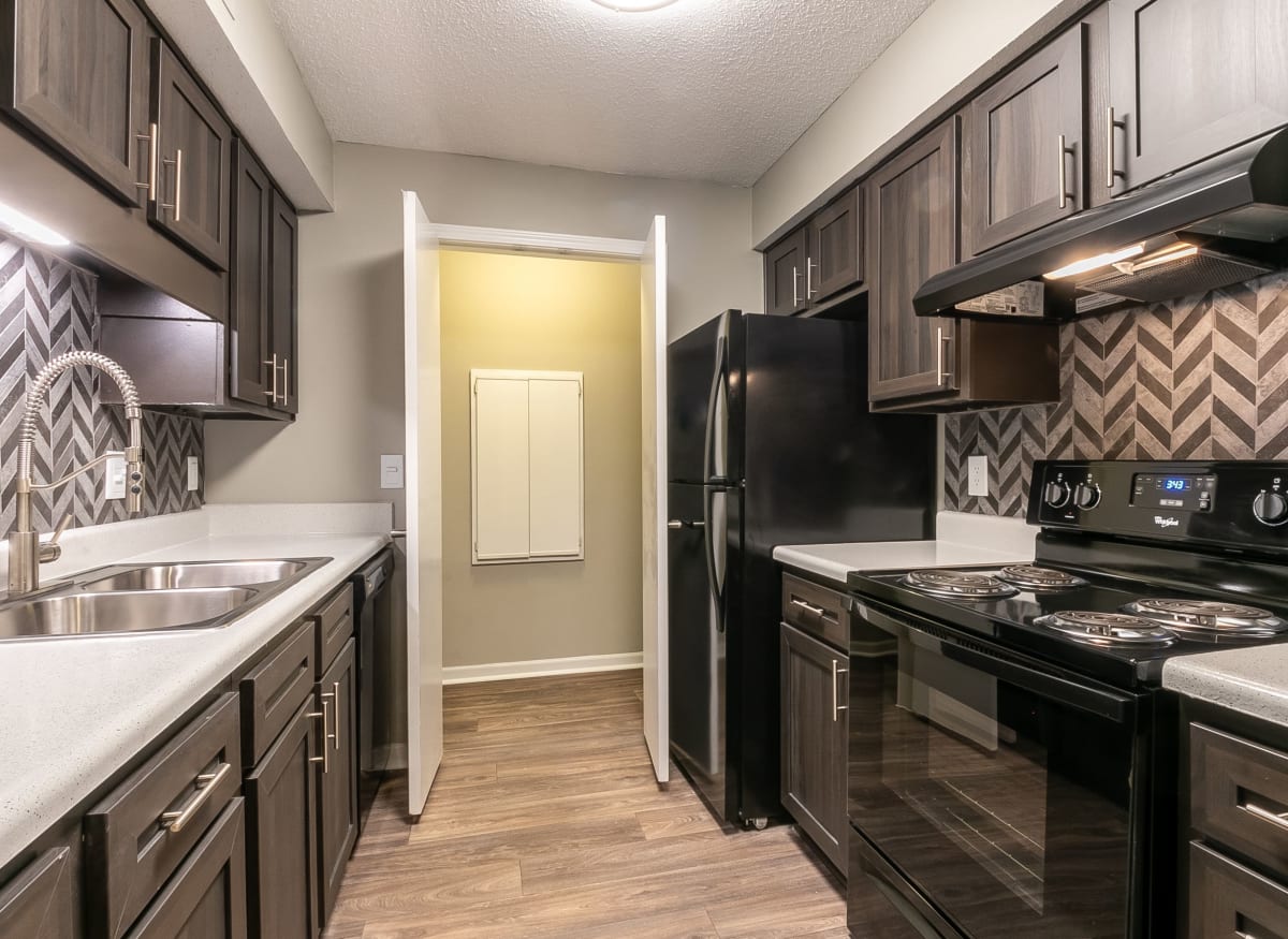 Modern kitchen with black appliances at The Square at Lawrenceville in Lawrenceville, Georgia