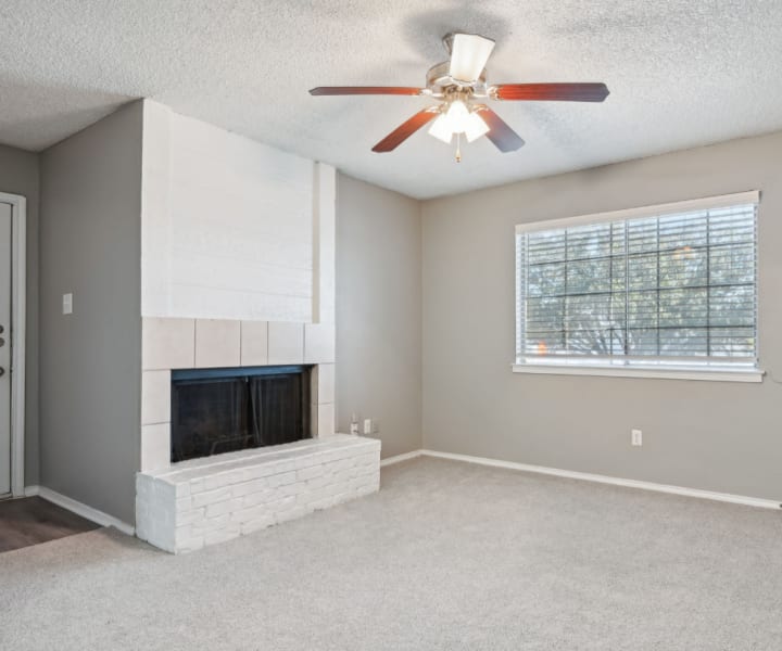 Living room with a fireplace at Courts of Bedford in Bedford, Texas