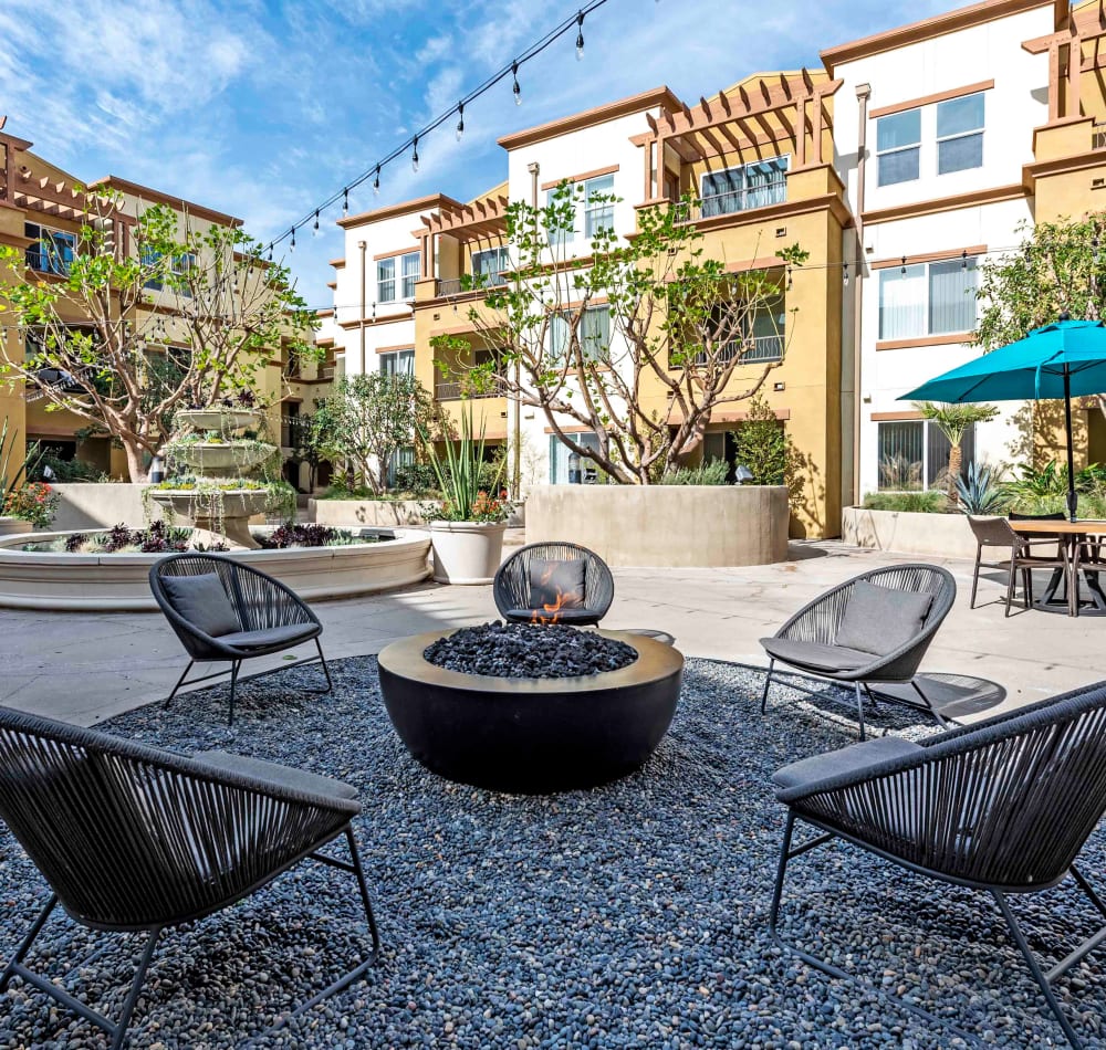 Fire pit area with beautifully maintained flora nearby at Sofi at Topanga Canyon in Chatsworth, California