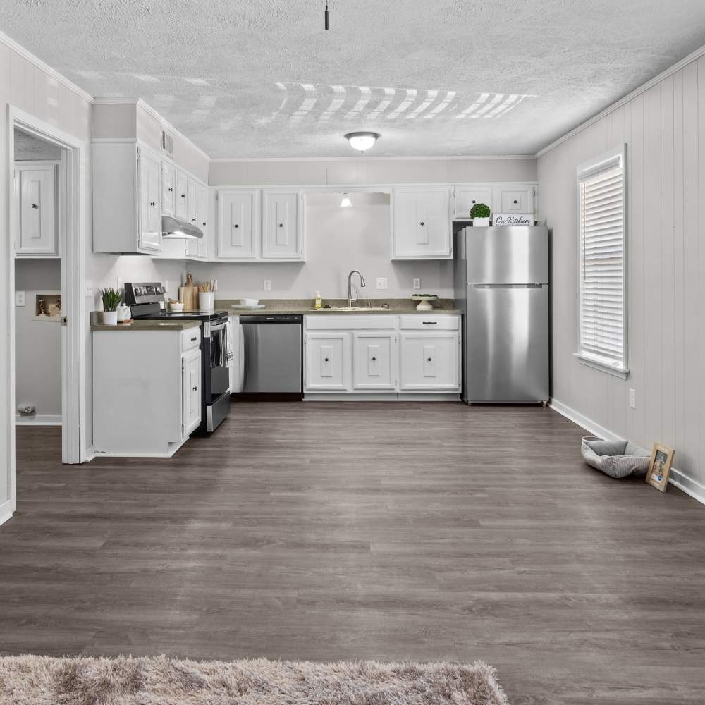 Modern kitchen at Pecan Ridge in Vicksburg, Mississippi with sleek cabinets and stainless steel appliances, exuding charm and functionality.