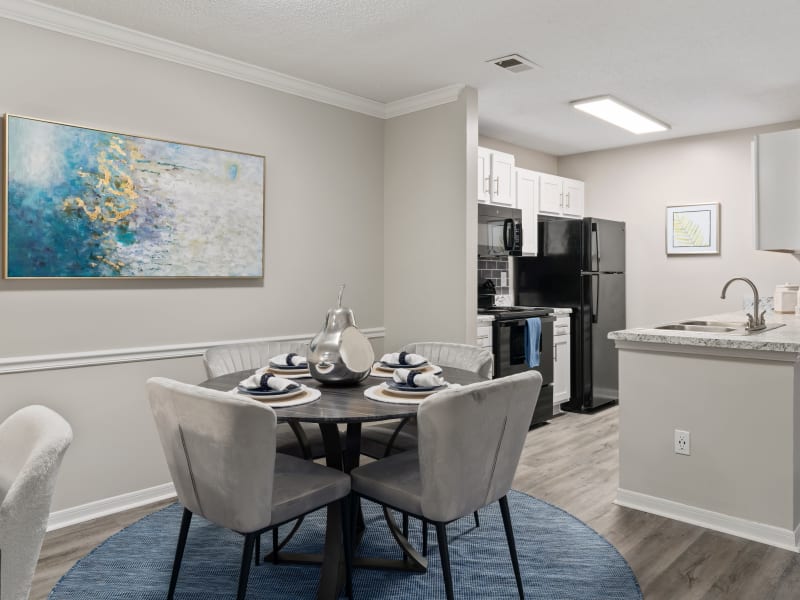 Wood flooring in a model kitchen and dining room at Lenox Gates in Mobile, Alabama