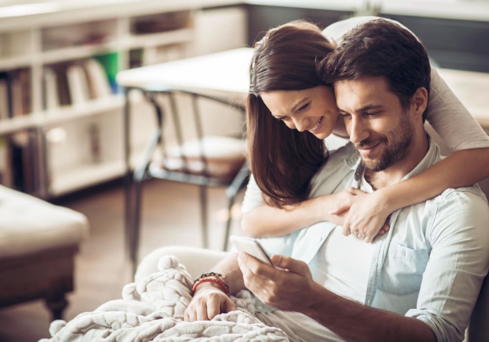Residents applying on their phone to live at The Villas at Woodland Hills in Woodland Hills, California