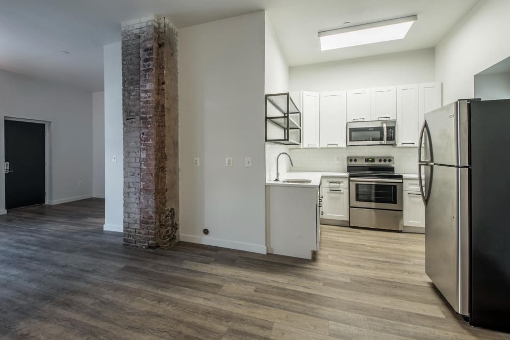 Kitchen with stainless steel appliances at Brush Factory Lofts in Philadelphia, Pennsylvania
