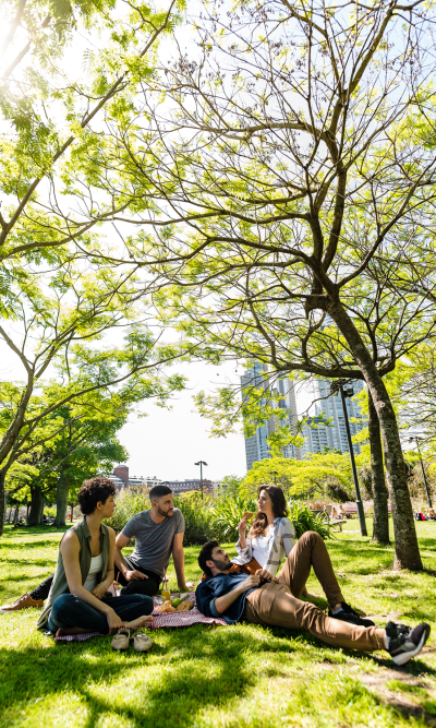 Residents relaxing under a tree at Gardenbrook Apartments in Columbus, Georgia