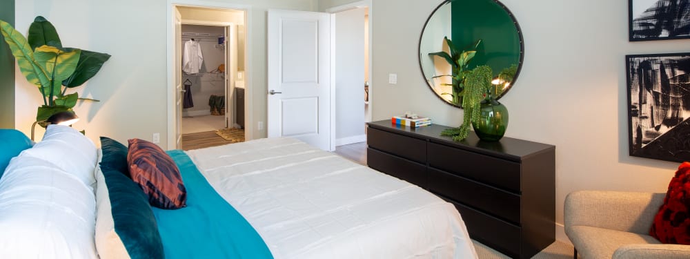 A bedroom with on-suite bathroom and plenty of closet space at Jefferson SoLA in South Gate, California