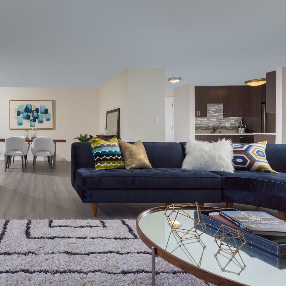 View of the dining and kitchen areas from the open-concept living space of a model home at Sofi Belmont Glen in Belmont, California