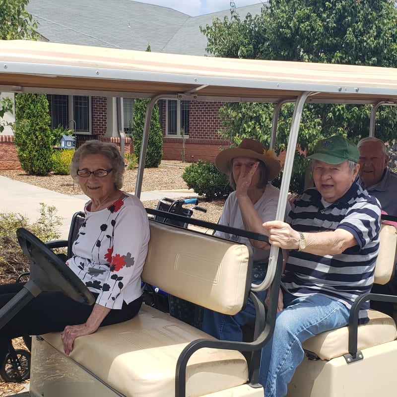 Residents in a golf cart at a Presbyterian Communities of South Carolina community