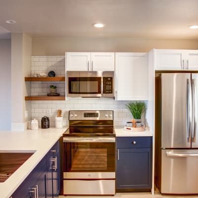 Newly renovated kitchen with stainless-steel appliances and a subway tile backsplash in a model home at Harbor Point Apartments in Mill Valley, California