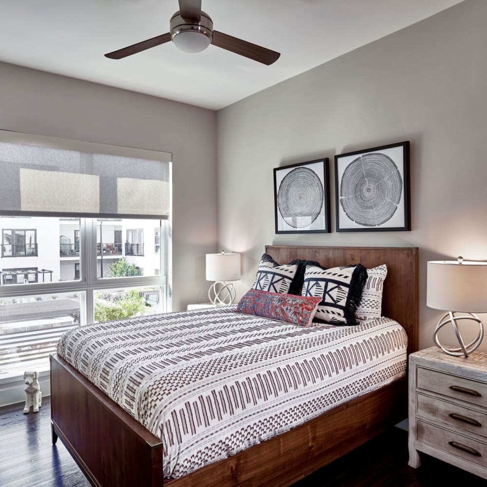 Bedroom furniture and ceiling fan at model unit at Harvest Lofts in Dallas, Texas