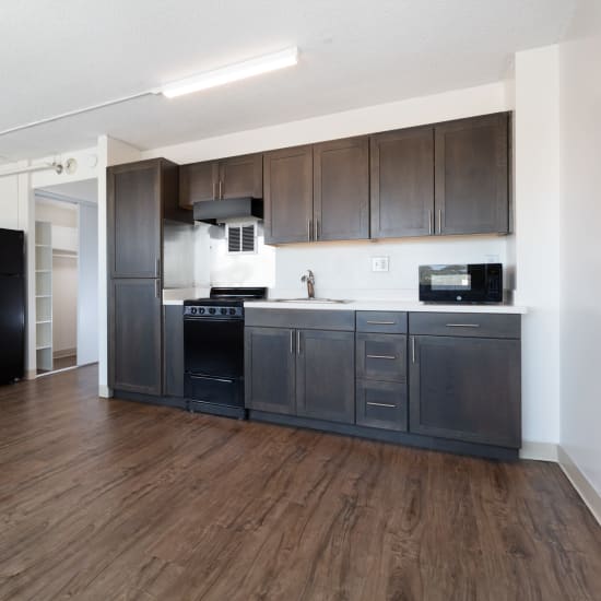 Demonstration kitchen and table for dining or games in the community room at Golden West Tower Apts in Torrance, California