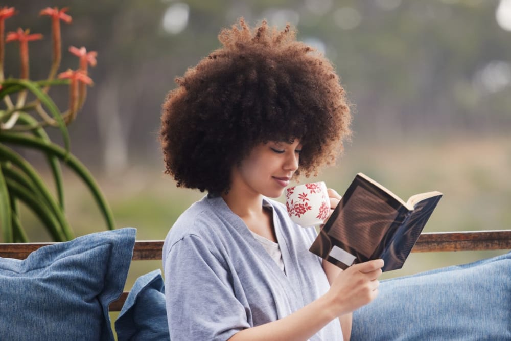 Resident readying a book  at Oceana Apartments in Huntington Beach, California