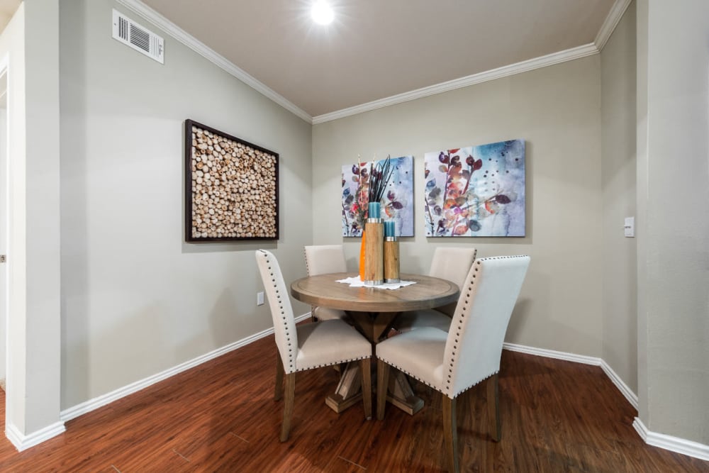 Dining room with wood style flooring at Marquis at Ladera Vista in Austin, Texas