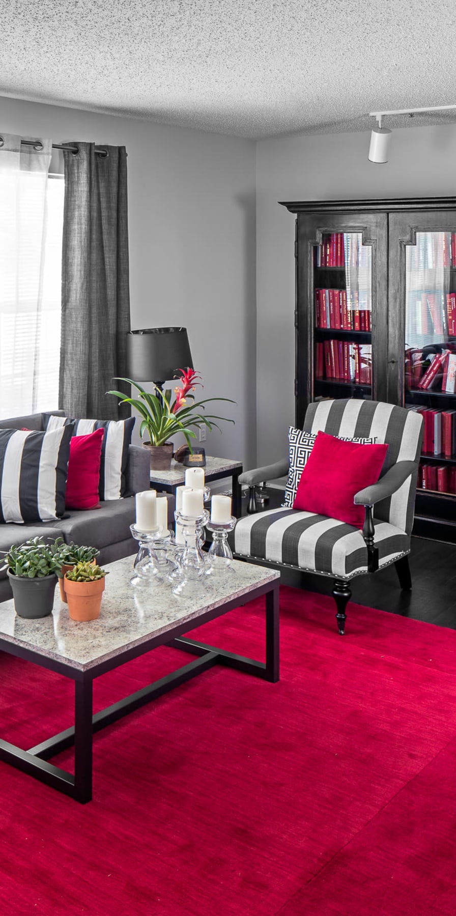 Modern resident lounge with a large bookcase at The Gramercy in Manhattan, Kansas