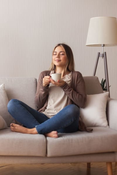 A resident enjoys a cup of coffee in her apartment at Kaitlin Court, Los Angeles, California