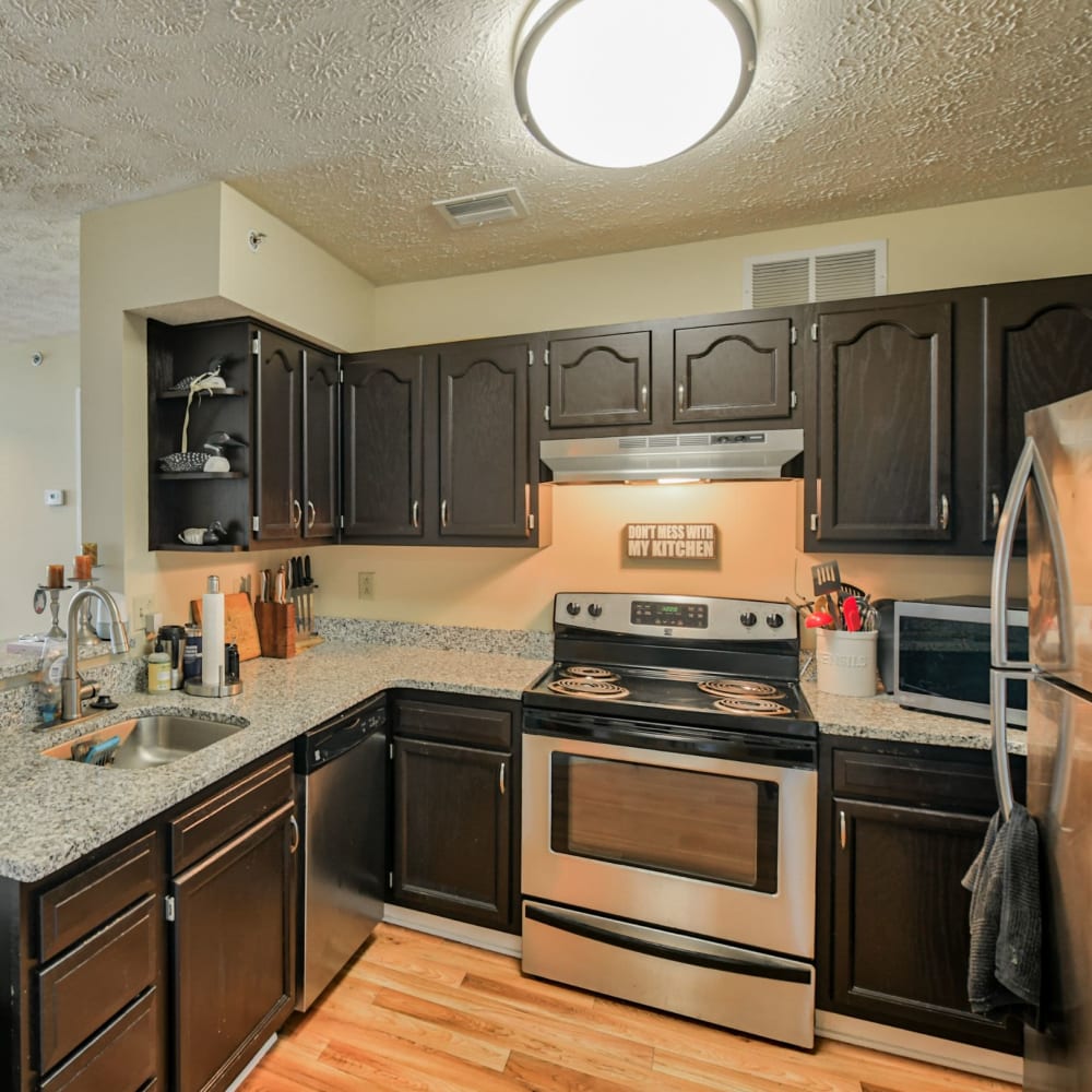 Kitchen with stainless-steel appliances at wood-style flooring at Parkside Estates, Canonsburg, Pennsylvania