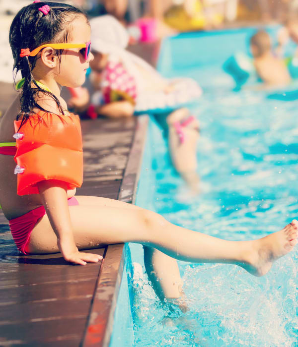 Resident child enjoying the swimming pool at Eagle Rock Apartments at Mohegan Lake' tennis court in Mohegan Lake, New York