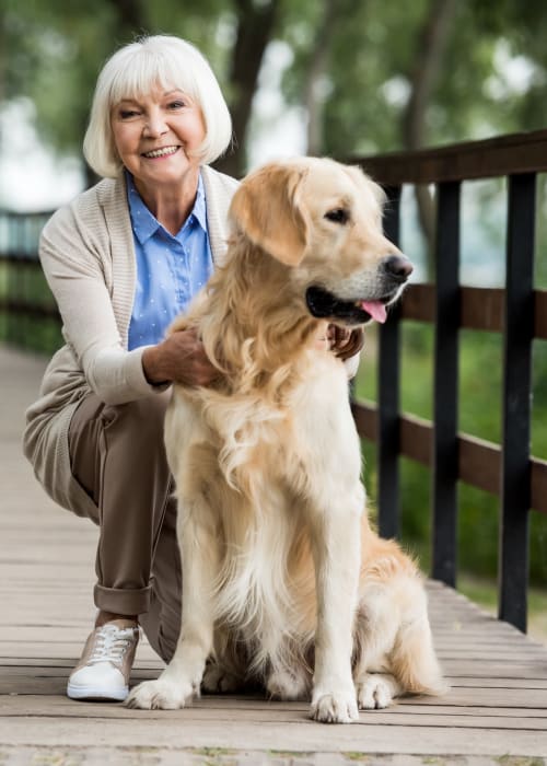 Resident with a dog at The Pillars of Hermantown in Hermantown, Minnesota