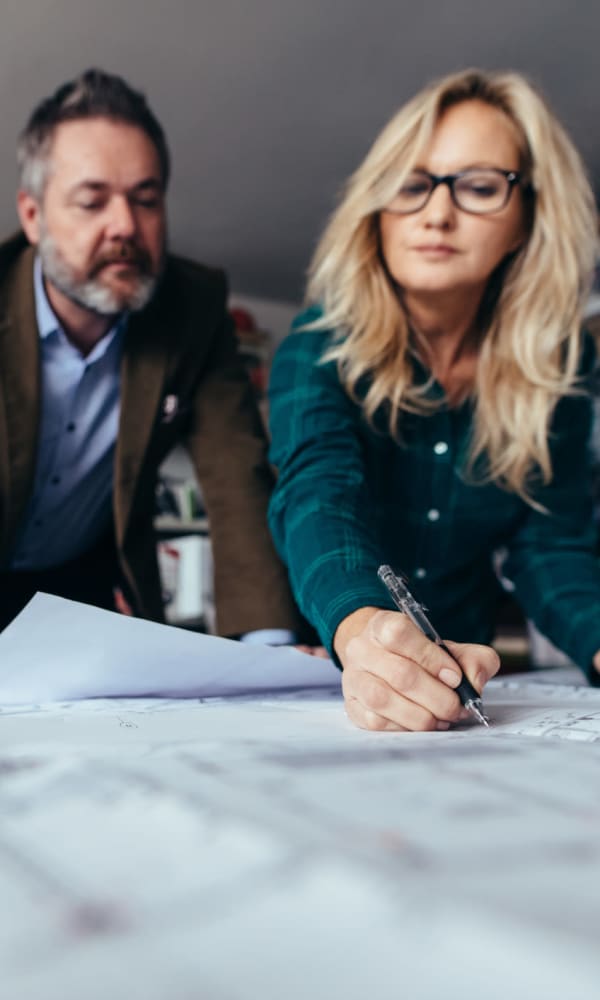 Employees going over designs and paperwork at TM Real Estate Group in Coconut Grove, Florida