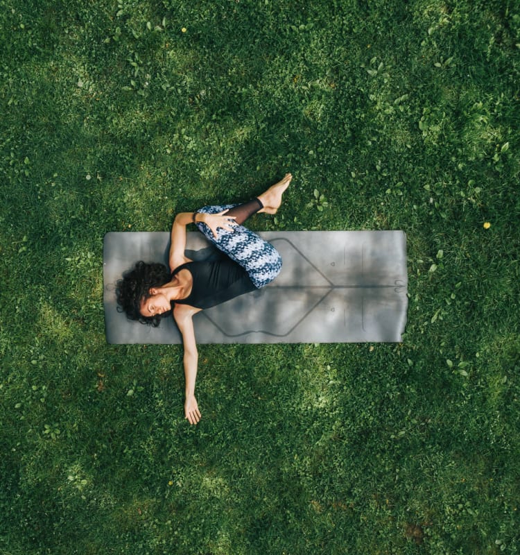 Resident doing yoga in one of the parks near Fountain House Apartments in Miami Lakes, Florida