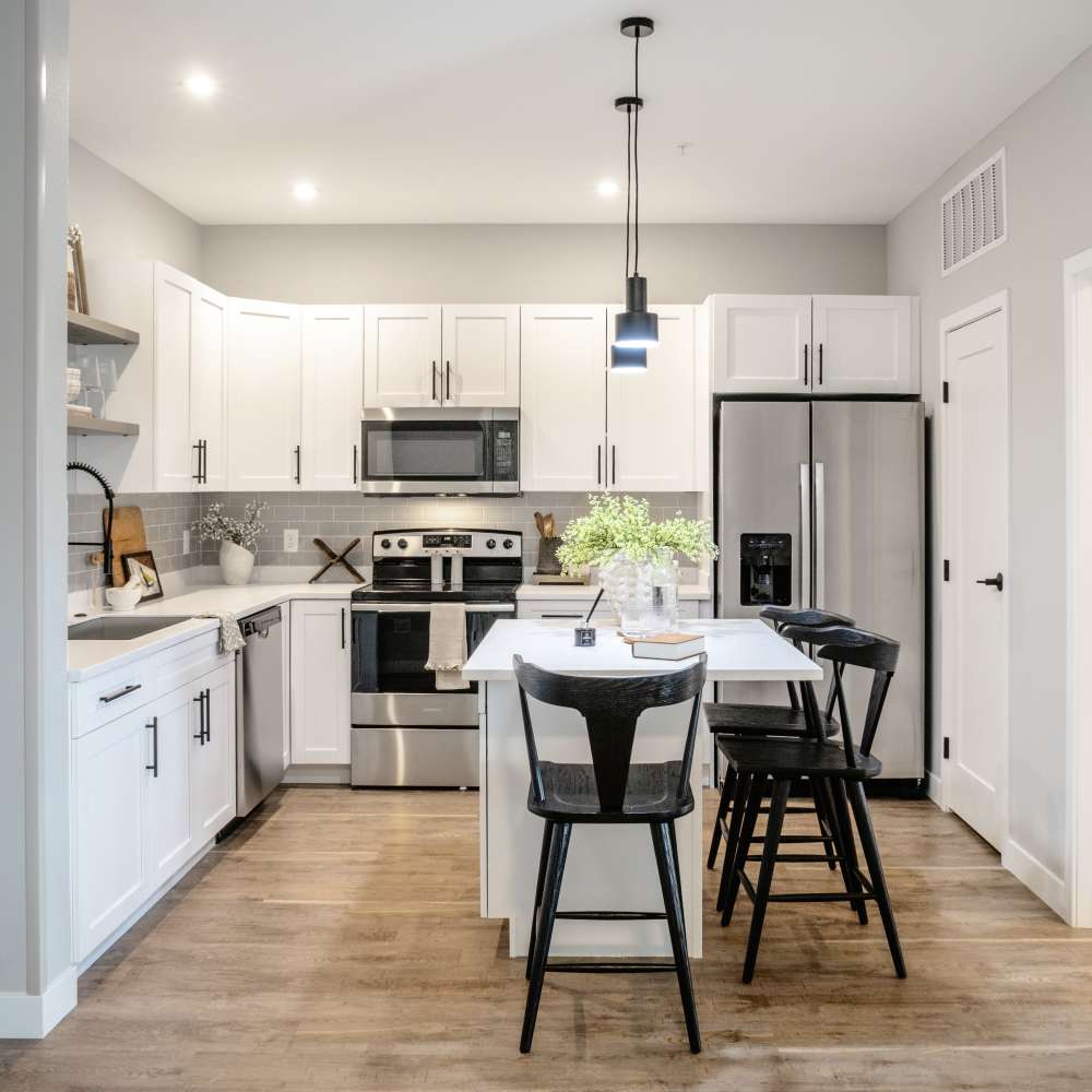 Open kitchen with island countertop and barstool at InterUrban 2.0 in Billings, Montana