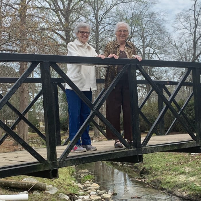 Residents walking on a bridge at The Florence Presbyterian Community in Florence, South Carolina