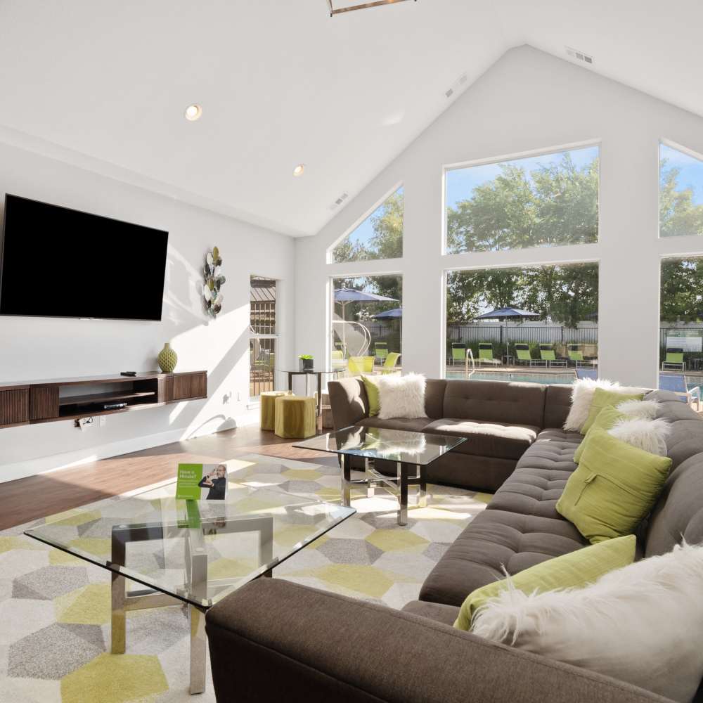 Clubhouse seating space with wall mounted tv at Vida Apartments in St. Charles, Missouri